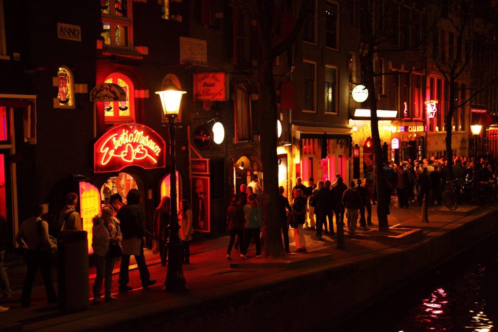 Street in Amsterdam with red lights and night atmosphere