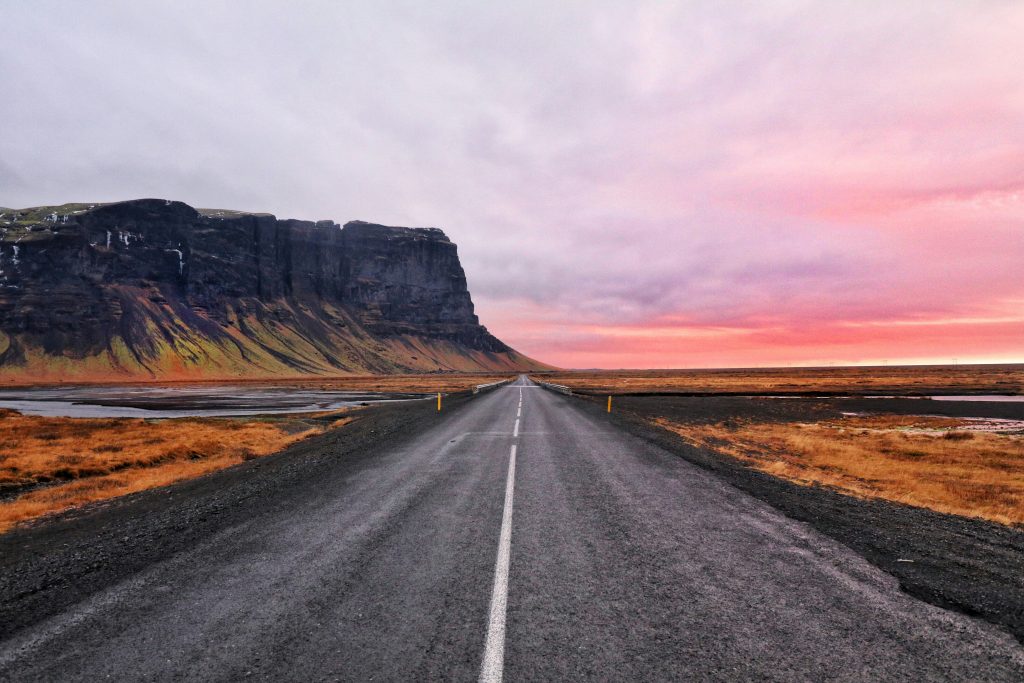 Iceland Ring Road with car driving through mountains and open landscape – Iceland travel guide