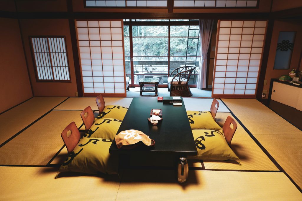 Traditional Japanese ryokan room with tatami mats and futon bedding in a calm setting