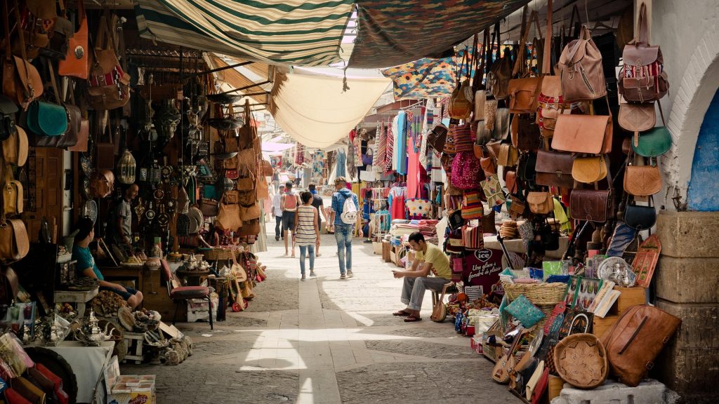 Morocco travel guide – busy traditional souk in Morocco with spices, textiles and crafts