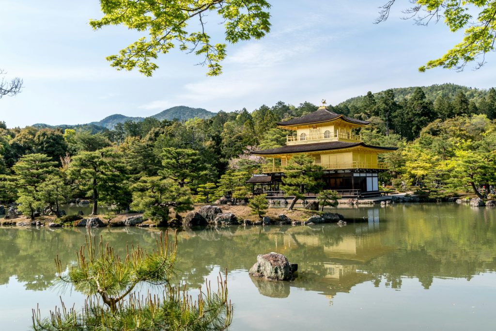 Kinkaku-ji Golden Pavilion in Kyoto reflected in water with scenic surroundings – Kyoto travel guide