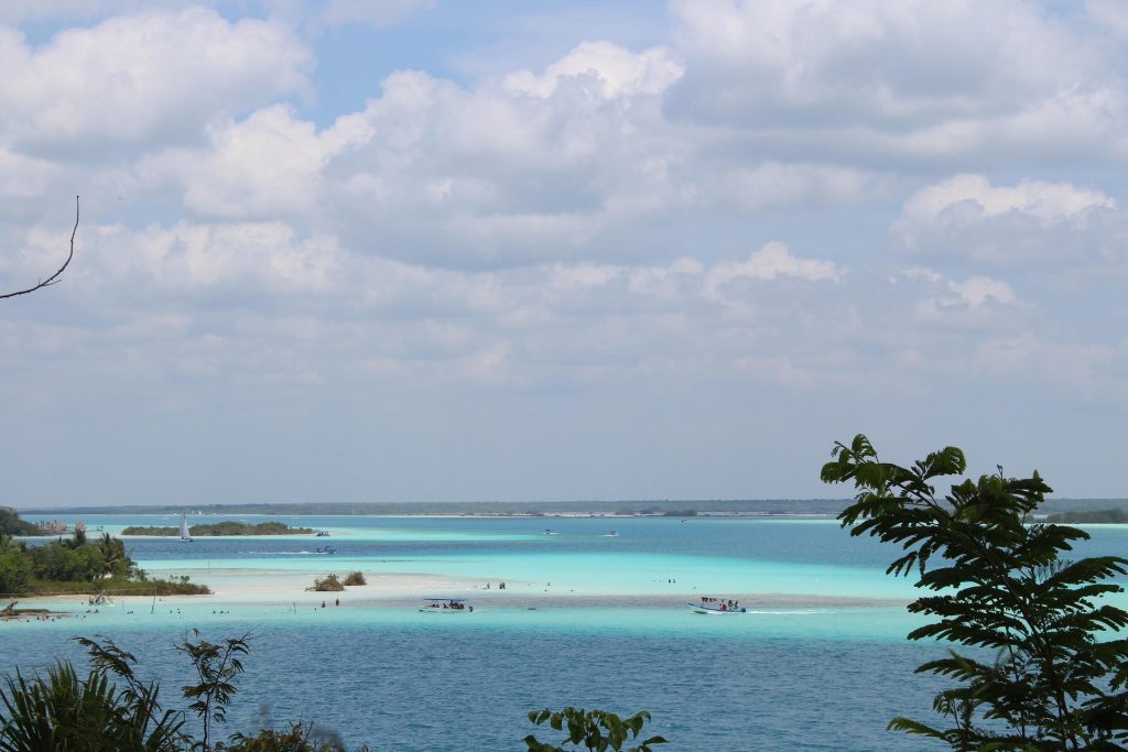 Bacalar Lagoon Mexico with vibrant blue shades calm water and wooden dock scenery