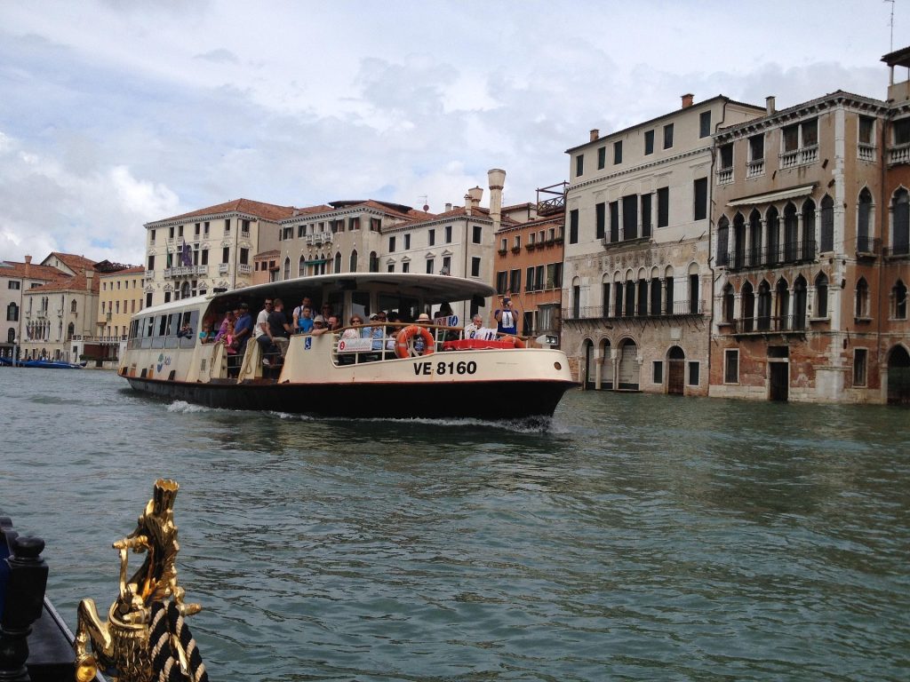 Vaporetto water bus on the Grand Canal in Venice, passing historic Venetian buildings