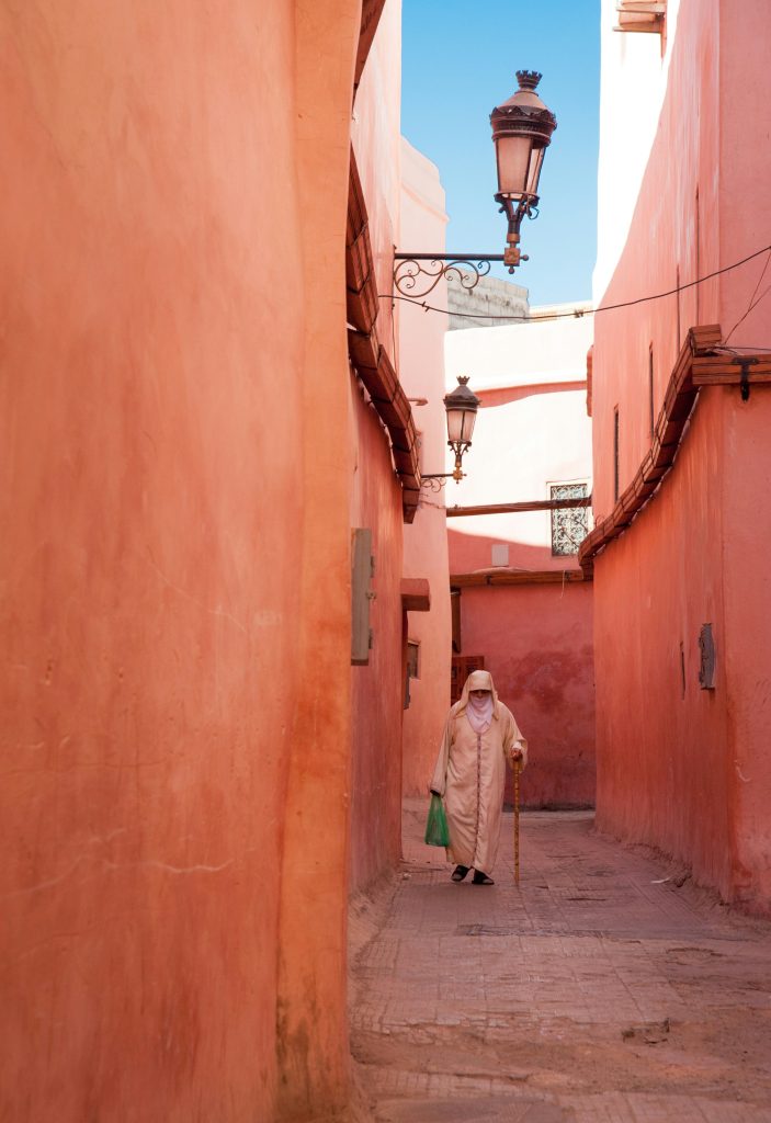Narrow alley with red walls in the Marrakech medina