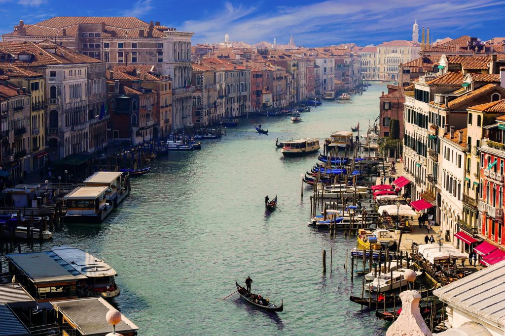 View of the Grand Canal in Venice, lined with historic palaces, boats, and gondolas