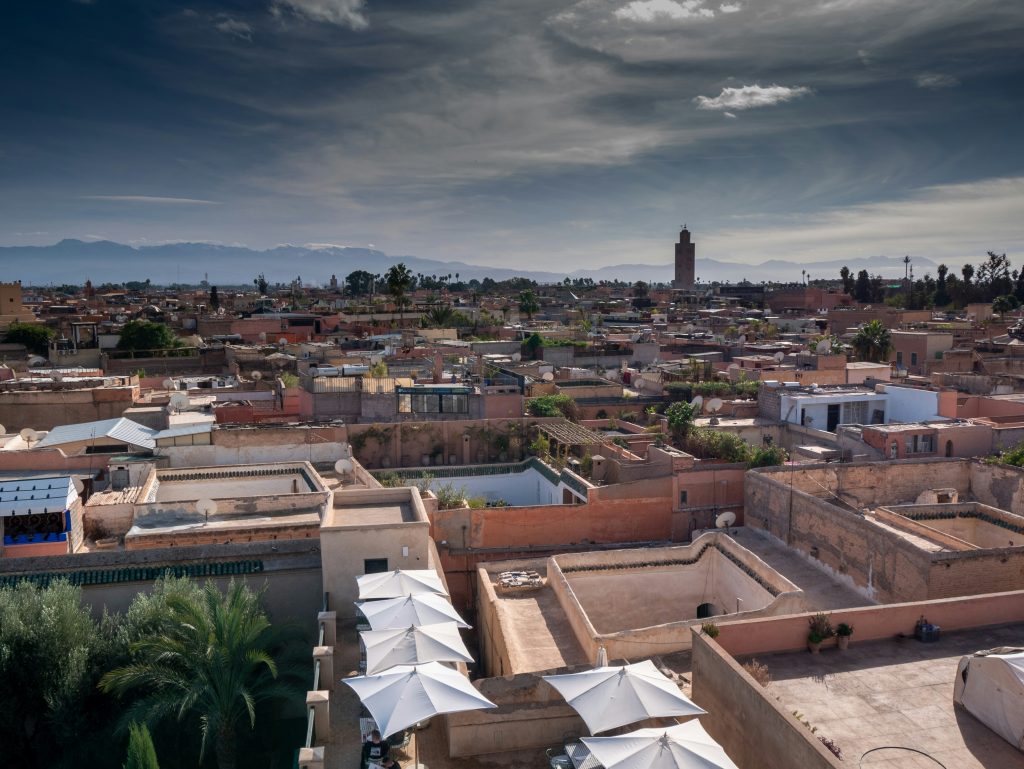 Rooftop view over the city with distant mountains and mosque tower