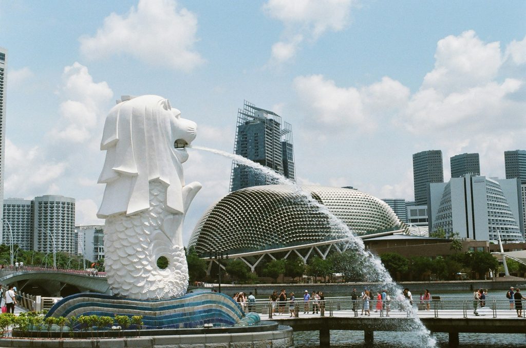 Merlion fountain with Singapore waterfront skyline and modern buildings in the background