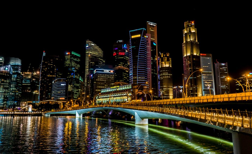 Singapore skyline at night with colorful street lights and busy city atmosphere