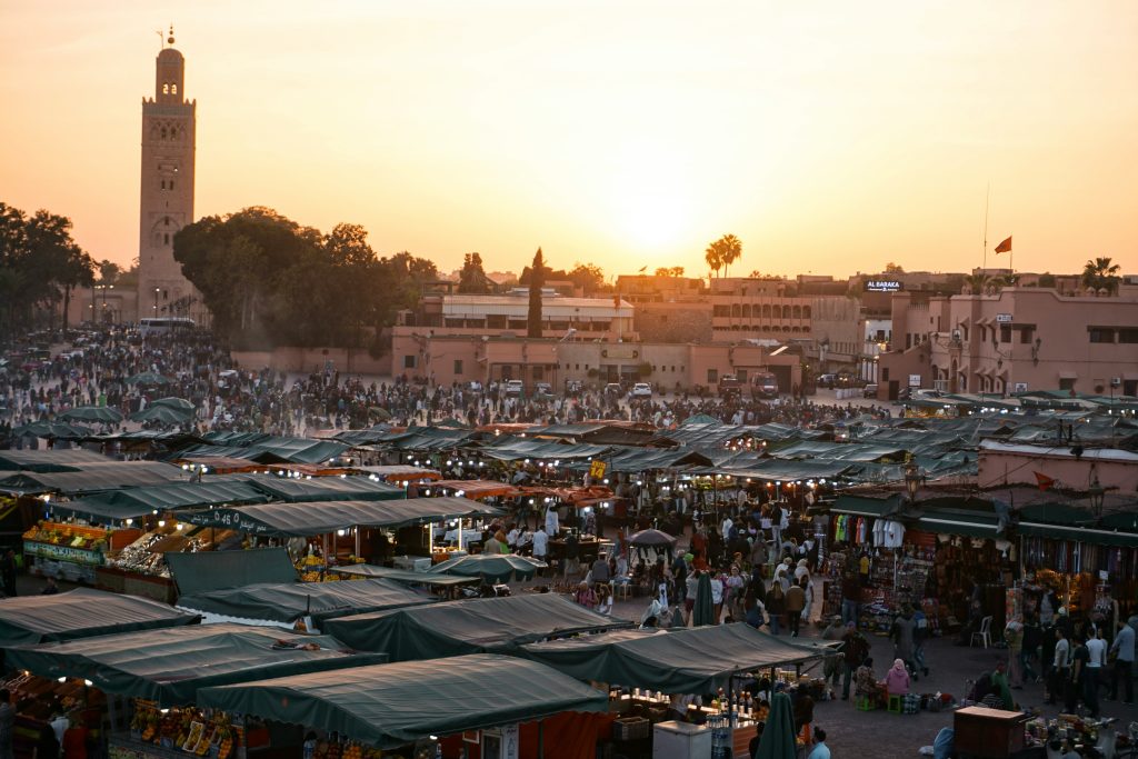 Crowded Jemaa el-Fnaa market in Marrakech at sunset