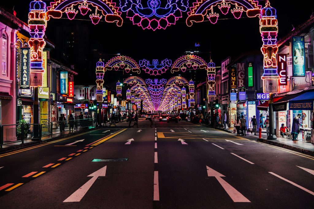 Little India street at night decorated with bright festive lights and lively city atmosphere