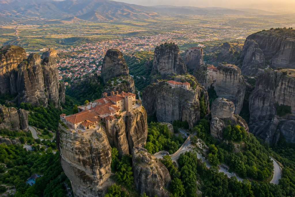 Aerial view of Meteora monasteries perched on dramatic rock pillars above Kalambaka, Greece.