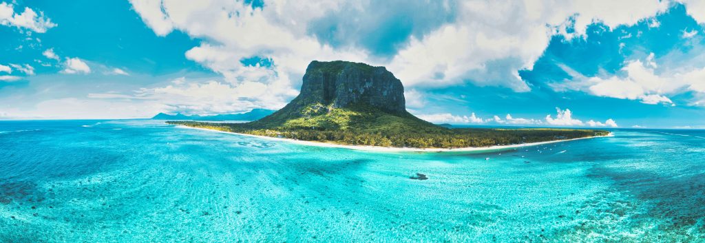 Aerial view of Le Morne Brabant peninsula surrounded by turquoise lagoon waters